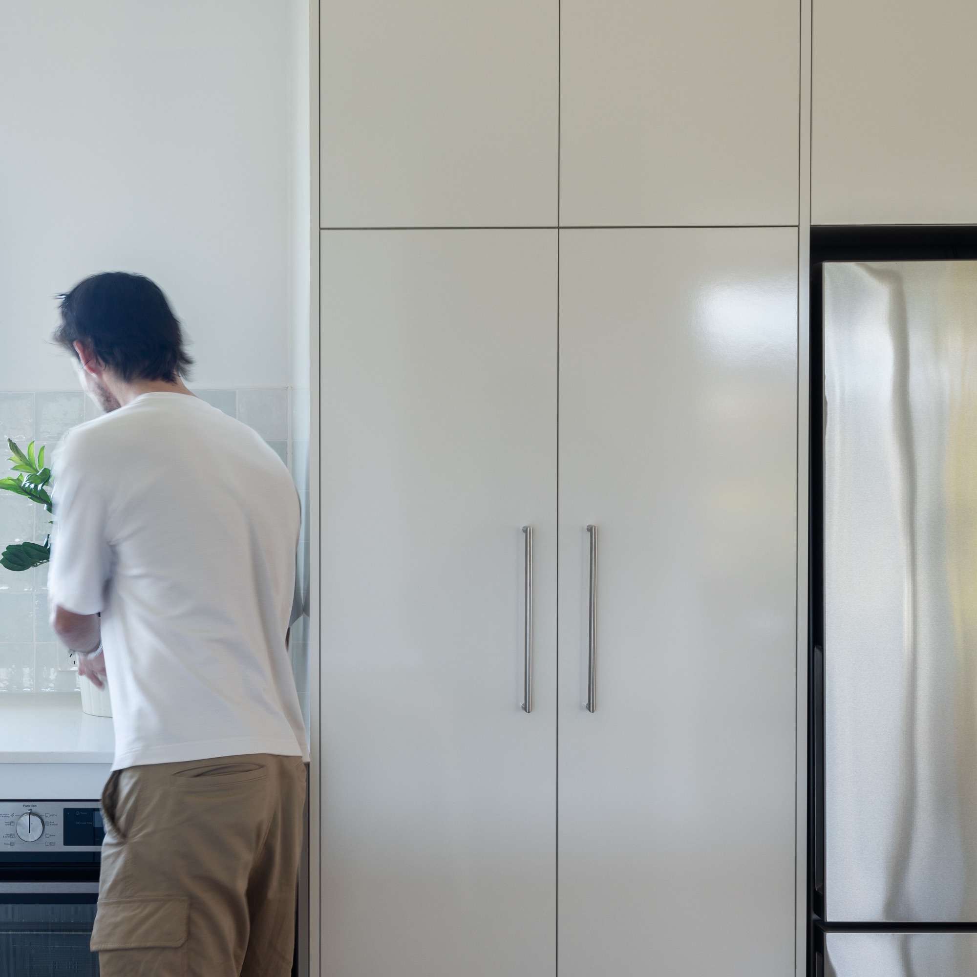 Finished North Narrabeen joinery, tall white cabinets beside the kitchen